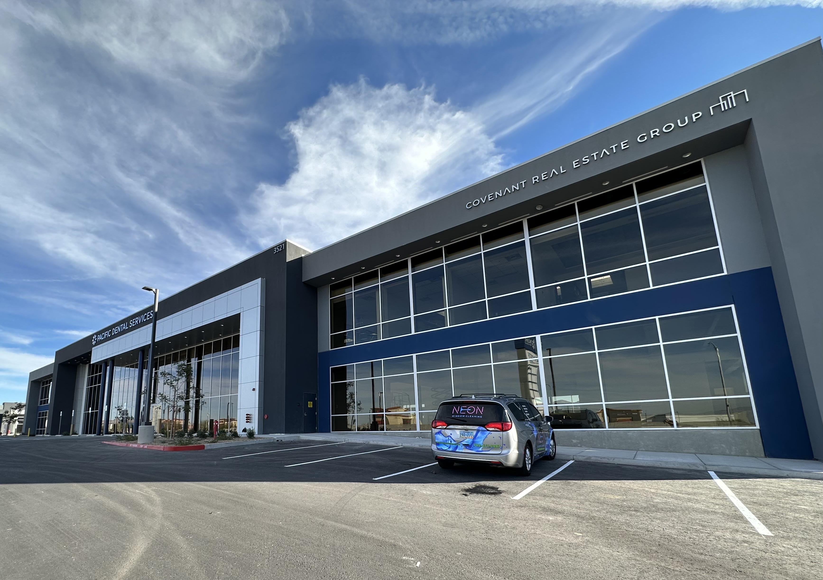 Commercial office building with clean glass and a Neon Window Cleaning vehicle in Las Vegas