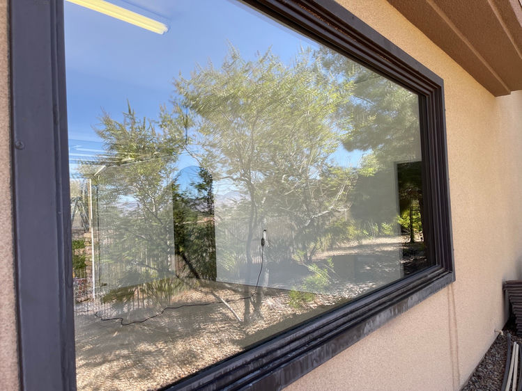 Crystal-clear picture window after professional hard water stain removal in Las Vegas