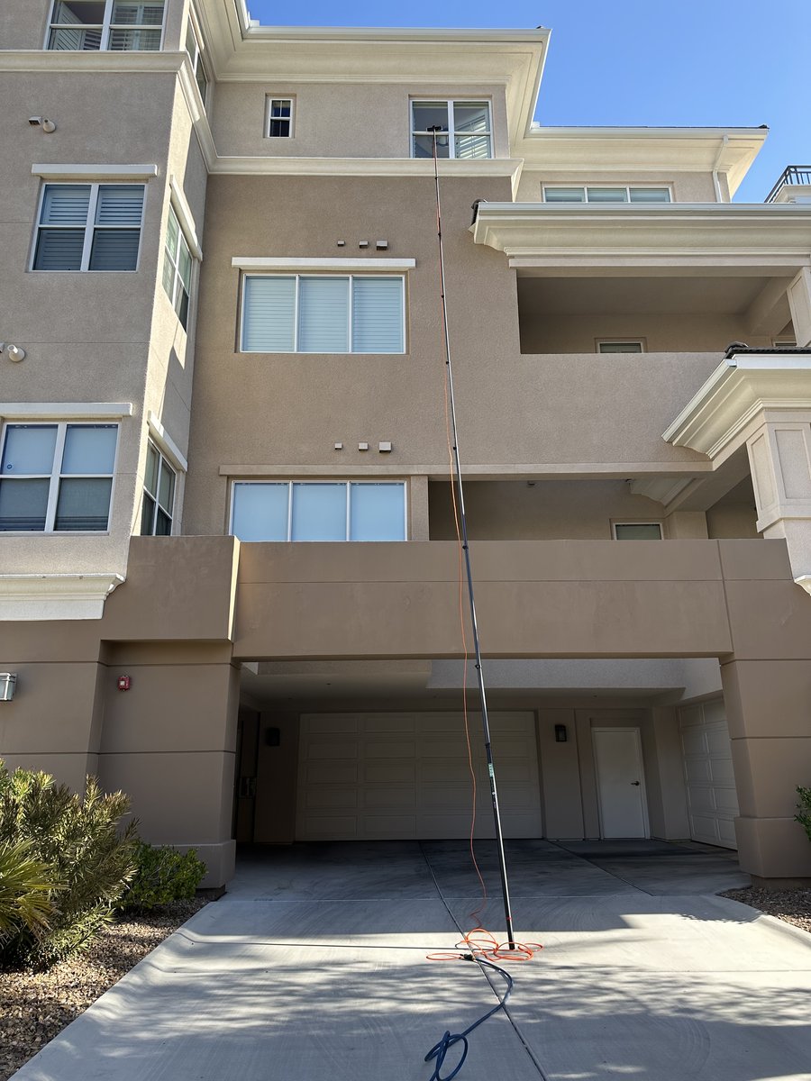Multi-story Las Vegas residential townhomes with clean windows in a desert community