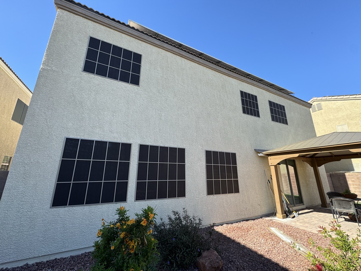 Custom solar screens installed on a residential Las Vegas home, blocking heat and UV across multiple windows