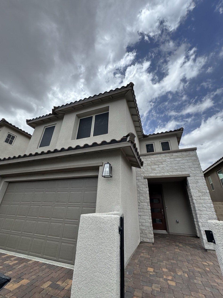 Two-story Las Vegas home with custom solar screens installed across multiple windows for full-house heat and UV protection