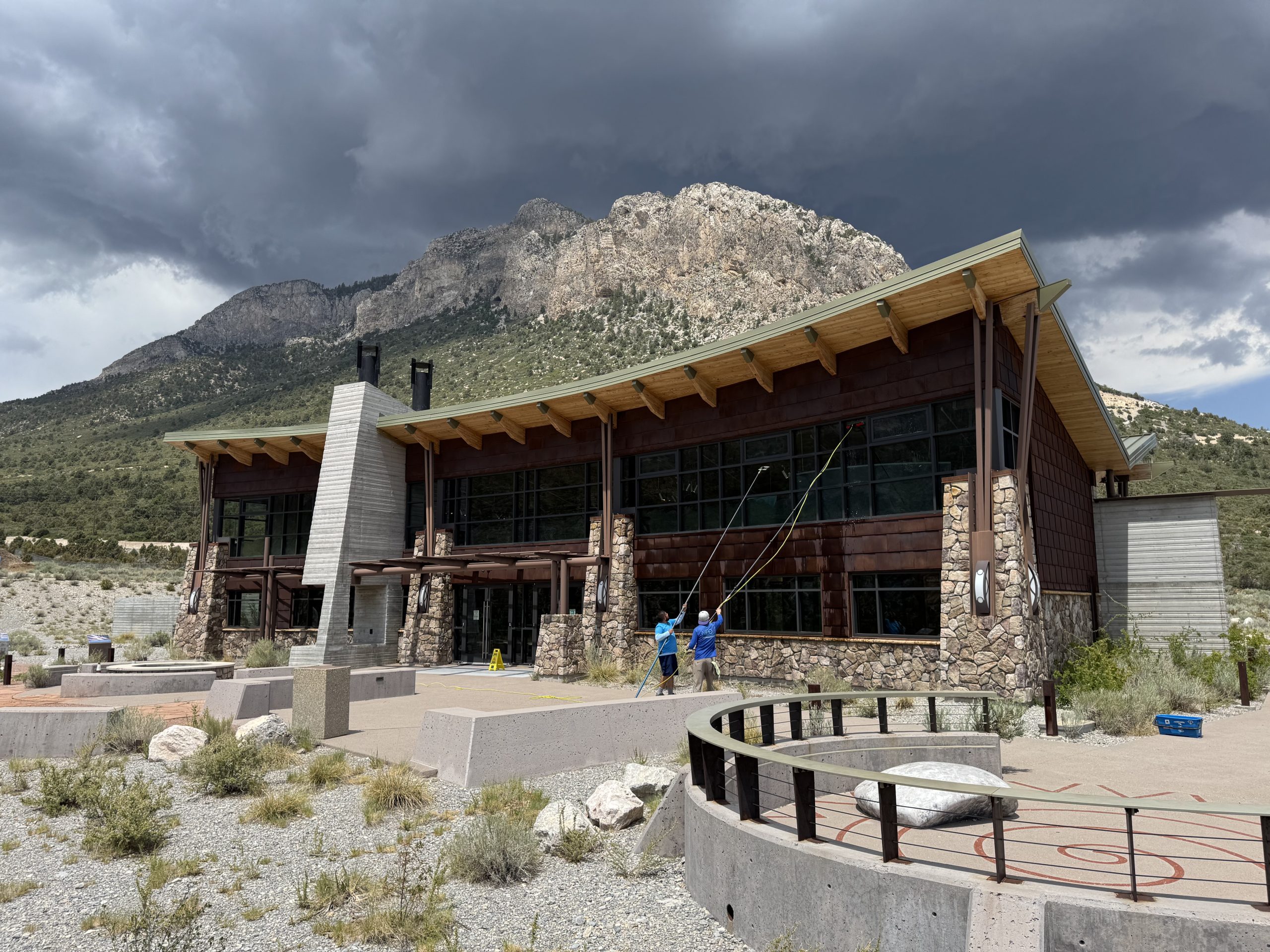 Neon Window Cleaning technician using water-fed poles to wash exterior windows on a commercial building in Nevada
